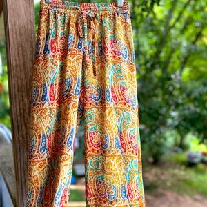 Silky wide-leg pants with elastic waistband and fabric tie.